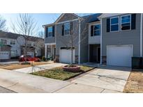 Well-maintained townhome featuring gray siding, stone accents, attached garages, and a manicured lawn at 1475 Cypress Loop # 29, Newton, NC 28658