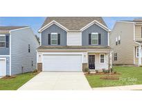 Two-story house with gray and white siding, white garage door, and landscaping at 2503 Trollinger Dr, Catawba, NC 28609