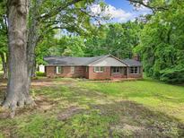 Charming brick ranch-style home with a well-maintained lawn and mature trees offering shade at 2988 Great Falls Hwy, Lancaster, SC 29720