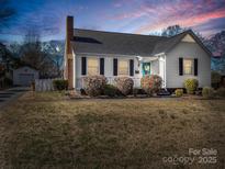 Charming white house with a manicured lawn and a blue door at 201 Ware St, Shelby, NC 28150