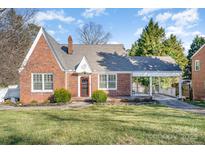 Charming brick home featuring a covered carport and well-maintained front lawn at 221 W Stewart Ave, Mooresville, NC 28115