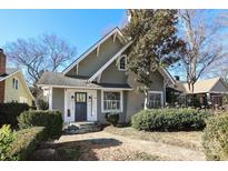 Charming craftsman-style home featuring a stone pathway, stylish front door, and mature landscaping at 2304 Dilworth W Rd, Charlotte, NC 28203