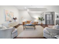 Bright living room featuring modern furnishings, hardwood floors, and neutral color palette at 287 Mcdonald Ave, Charlotte, NC 28203