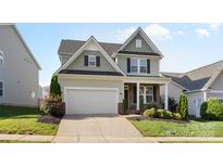 Charming two-story home with a two-car garage, manicured landscaping, and welcoming front porch at 4866 Breden St, Kannapolis, NC 28081