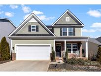 Charming two-story home with inviting brick-accented porch and well-maintained front yard at 4866 Breden St, Kannapolis, NC 28081