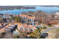 Stunning aerial view of lakeside condos, featuring beautiful lake views and community pool at 753 Southwest Dr, Davidson, NC 28036