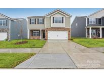 Charming two-story home with brick and siding, featuring a two-car garage and manicured lawn at 8032 Plymouth Dr, Sherrills Ford, NC 28673
