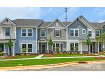 Charming townhome with a well-manicured lawn, colorful facade, and inviting curb appeal at 10115 Mamillion Dr, Huntersville, NC 28078