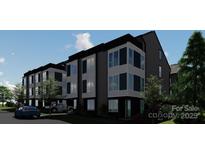 Modern townhome with a sleek design featuring large windows and a stylish black and white color scheme at 111 Verbena Ne St # 10, Charlotte, NC 28217