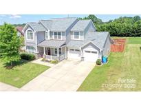 Charming two-story home with a two-car garage, covered porch, and well-maintained front yard at 1148 Mckee Farm Ln, Belmont, NC 28012