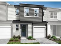 Modern two-story townhome with gray siding, two-car garage, and landscaping at 2114 Endeavor Run, Charlotte, NC 28269
