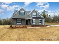 Charming two-story home with a covered front porch and beautifully landscaped front yard at 4021 Harmattan Dr, Denver, NC 28037