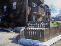 Exterior view of the apartments and signage, with wood siding and picket fence in the front at 813 Alexander St, Statesville, NC 28677