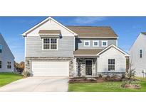Charming two-story home featuring a mix of stone and siding, attached two-car garage, and well-maintained landscaping at 1713 Wooten Way, Bessemer City, NC 28016