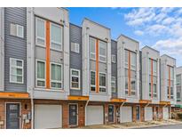 Modern townhome exterior featuring a brick facade, gray siding, and large windows under a blue sky at 3617 Vallette Ct, Charlotte, NC 28203