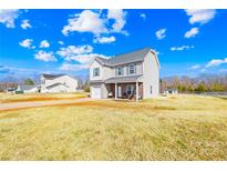 Charming two-story home with vinyl siding, attached garage, and landscaped yard under a sunny sky at 425 Webb Rd, Shelby, NC 28152