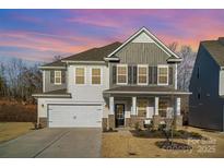 Charming two-story home with attached garage and covered front porch at 452 Kennerly Center Dr, Mooresville, NC 28115