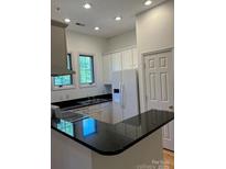 Modern kitchen features stainless steel appliances, granite counters, and ample cabinet space at 765 N Alexander St, Charlotte, NC 28202