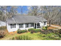 Charming single-story home with white siding and a well-manicured front yard at 7921 Fairmont Dr, Waxhaw, NC 28173