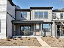 Two-story townhome with modern exterior, front porch, and landscaping at 95 Seven Oaks Lndg, Belmont, NC 28012