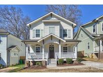 Charming two-story home with a welcoming front porch and well-maintained landscaping at 1211 Pinecrest Ave, Charlotte, NC 28205