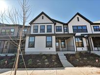 Modern 2-story townhome with white siding, black accents, and landscaped front yard at 207 Halemarge Drive Dr, Belmont, NC 28012