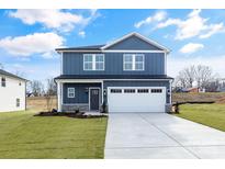 Two-story house with blue siding, white garage door, and landscaped lawn at 3020 Swallowtail Ln # 38, Kannapolis, NC 28023