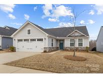 Charming single-Gathering home with a two-car garage, manicured lawn, and inviting front entrance at 4209 Jones Creek Ln, Charlotte, NC 28215