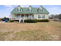 Charming two-story home with green metal roof and inviting front porch at 515 Brawley Rd, Cleveland, NC 27013