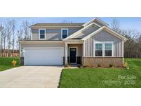 Two-story house with gray siding, brick accents, and a two-car garage at 821 Hallman Branch Ln, Lincolnton, NC 28092