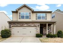 Charming two-story home featuring stone accents, a two-car garage, and a welcoming front porch at 912 Harbor Islands Ct, Gastonia, NC 28056