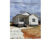 Newly constructed home with gray siding, a covered porch, and a landscaped yard at 1526 W Horah St, Salisbury, NC 28144