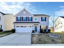 Charming two-story home with a well-manicured lawn and a two-car garage at 1686 Scarbrough Sw Cir, Concord, NC 28025