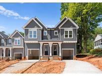 Modern grey duplex exterior featuring two-story design, garages, and stylish white trim at 2230 Revolution Park Dr, Charlotte, NC 28208