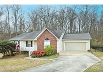 Brick ranch home with attached garage and landscaped yard at 234 Candle Nw Ct, Concord, NC 28027