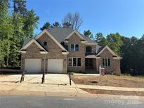 Stunning two-story brick home with a two-car garage and a beautifully designed front exterior at 2418 Lexington Approach Dr, Charlotte, NC 28262
