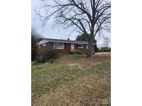Charming single-story brick home with well-maintained lawn and mature trees at 32269 Pennington Rd, Albemarle, NC 28001