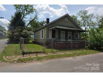 View of a two-story home with an enclosed front yard and partial shade at 529 Gage St, Chester, SC 29706