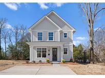 Charming two-story home with a modern farmhouse style, vertical siding, and a covered front porch at 709 N York St, Gastonia, NC 28052