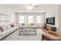 Bright living room with hardwood floors, plush rug, and modern furnishings at 8500 Union Central Ct, Waxhaw, NC 28173