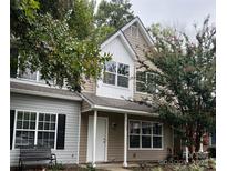 Two-story townhome with gray siding, white accents, and a small front yard at 9103 Exbury Ct, Charlotte, NC 28269