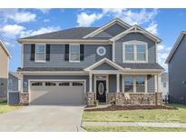 Charming two-story home with a two-car garage and a welcoming front porch at 1111 Fairbrae Ln, Indian Trail, NC 28079