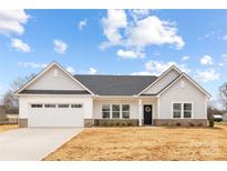 Charming single-story home featuring white siding, an attached garage, and a welcoming front porch with a wreath at 120 Random Dr, Salisbury, NC 28147