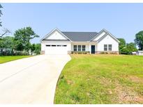 Charming single-story home boasting a well-manicured lawn, a two-car garage and long driveway at 120 Random Dr, Salisbury, NC 28147