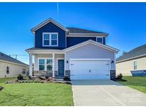 Two-story home showcasing a two-car garage, blue and grey siding, and a well-manicured lawn at 139 Aberdeen Dr, Salisbury, NC 28144