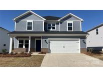 Charming two-story home with a two-car garage, gray siding, and a well-manicured lawn at 143 Aberdeen Dr, Salisbury, NC 28144