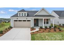 Charming single-Gathering home featuring a two-car garage, manicured lawn, and inviting front porch at 1726 Riverbend Ave # 177, Belmont, NC 28012