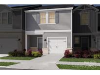 Charming townhome featuring gray siding, white garage door, and well-maintained landscaping at 5026 Kellaher Pl, Charlotte, NC 28216