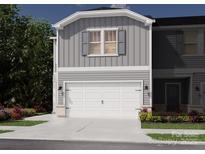 Charming two-story townhome with a white garage door, grey siding, and manicured landscaping at 5030 Kellaher Pl, Charlotte, NC 28216