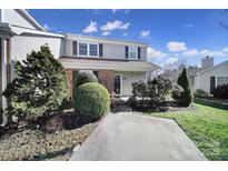 Charming two-story home with landscaped yard and brick accents on a sunny day at 6815 Cabot Cir, Charlotte, NC 28226